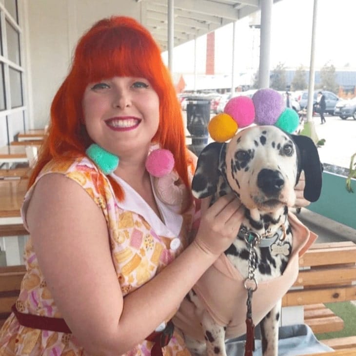 Woman posing for the camera in a dog friendly cafe in Melbourne with her pet