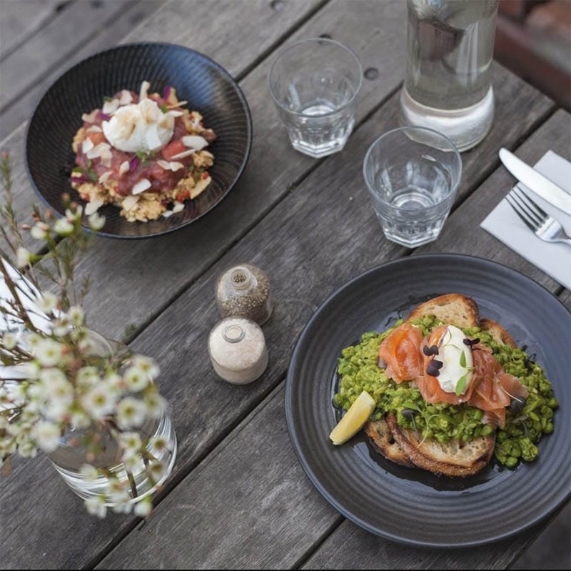In a werlcoming and dog-friendly atmosphere, this cafe in Melbourne serves plates of delicious and healthy food to the diners, such as this meal on top of the table.