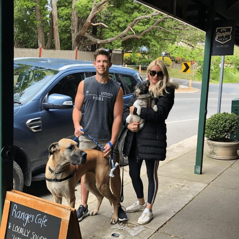 Man and woman standing outside a pet friendly cafe outside Eastern Melbourne